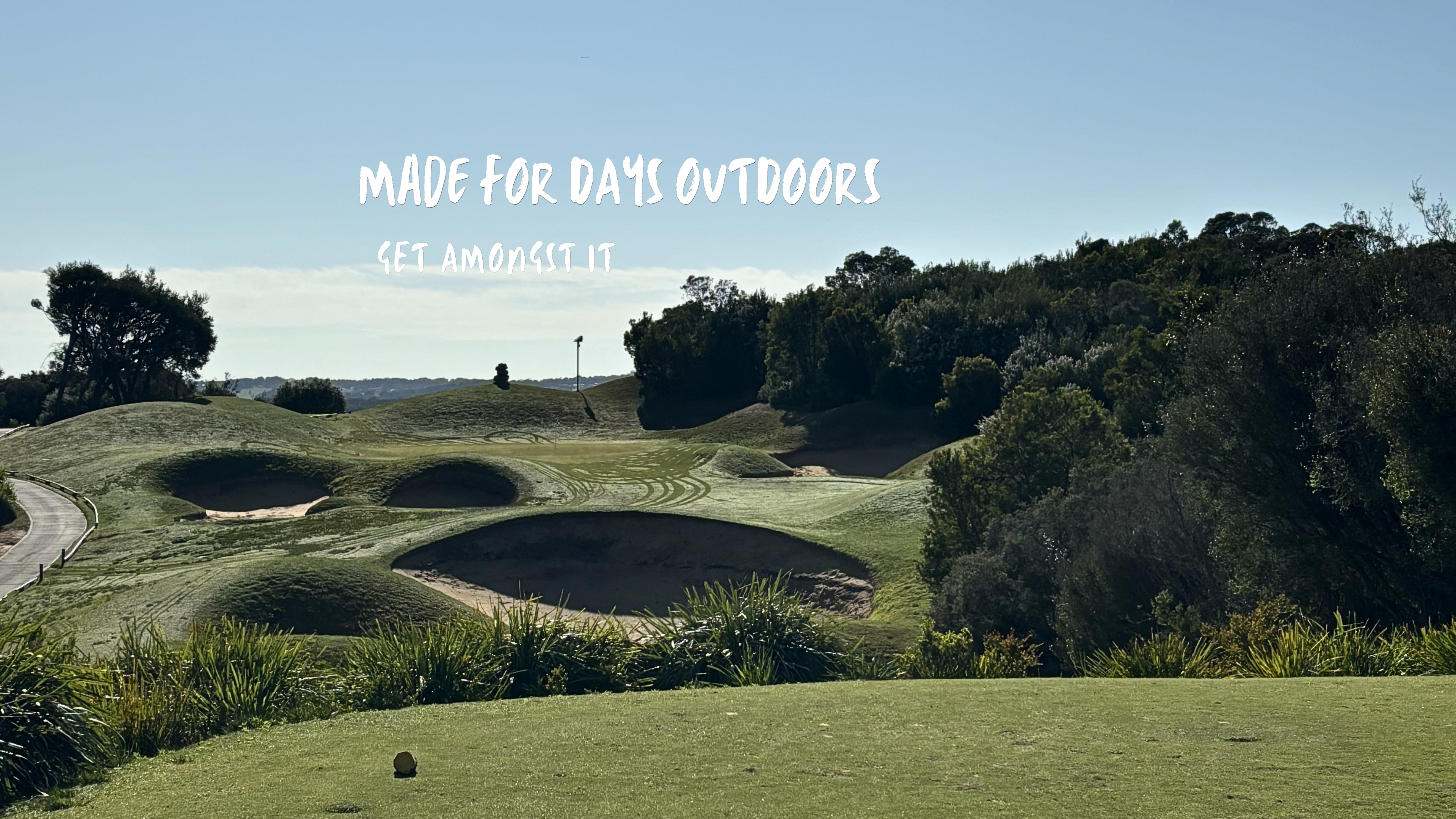 Golf course with sand bunkers and native Australian bushland.
